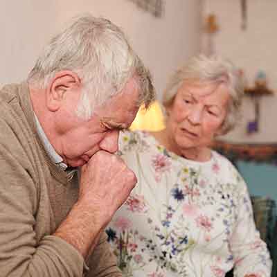 Older man experiencing chronic coughing. 